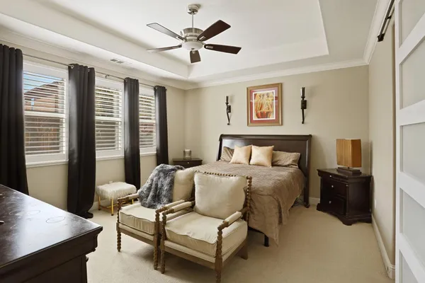 a spacious bedroom with a bed and a desk