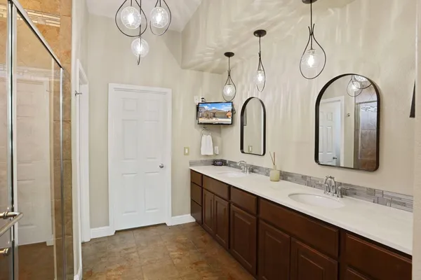 a bathroom with a double vanity sink and a mirror