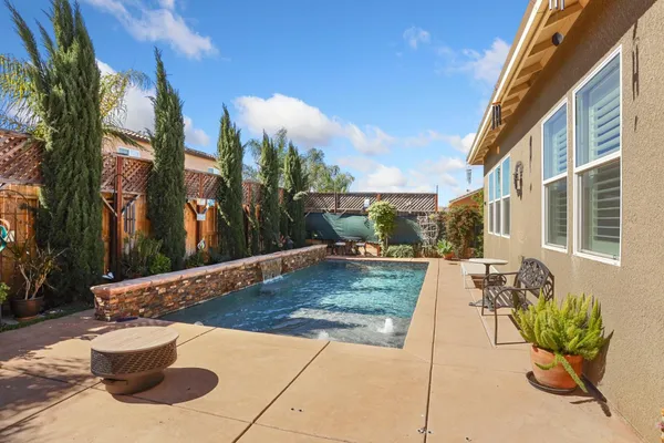 a view of a swimming pool with a patio