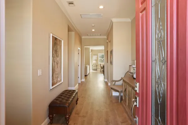 a view of a hallway with wooden floor and staircase