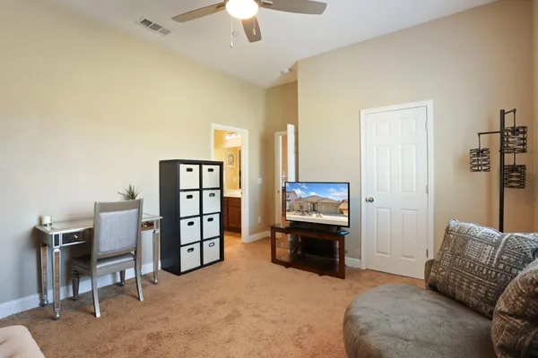 a view of a livingroom with furniture and workspace