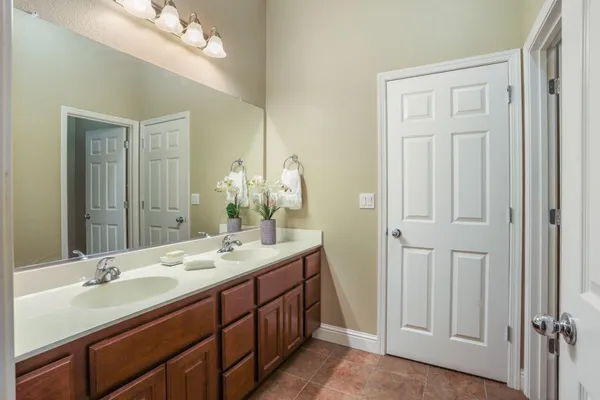 a bathroom with a double vanity sink and a mirror