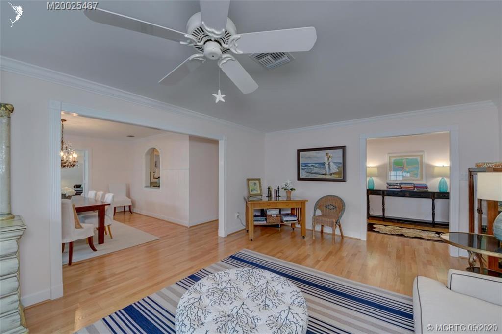 904 Southeast Riverside Drive Stuart, FL 34994 - Photo 17 of 72 a dining room with wooden floor and chandelier