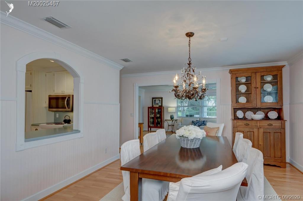 904 Southeast Riverside Drive Stuart, FL 34994 - Photo 21 of 72 a dining room with furniture potted plants and wooden floor