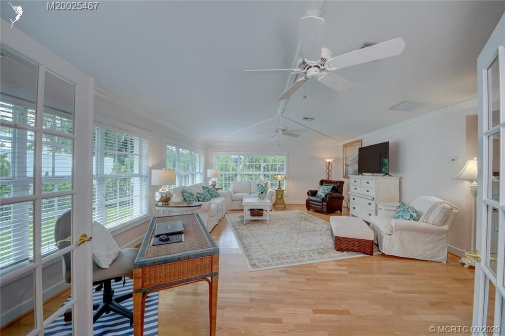 904 Southeast Riverside Drive Stuart, FL 34994 - Photo 23 of 72 a living room with fireplace furniture and a large window