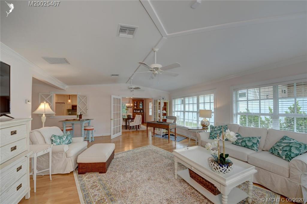 904 Southeast Riverside Drive Stuart, FL 34994 - Photo 25 of 72 a living room with furniture and a large window