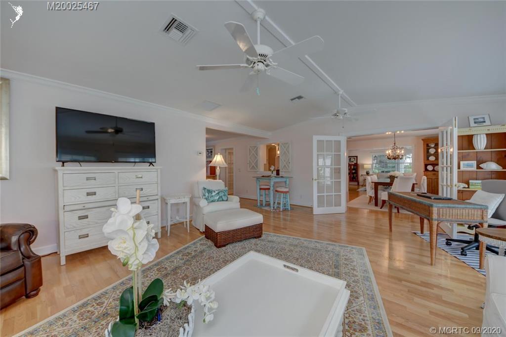 904 Southeast Riverside Drive Stuart, FL 34994 - Photo 26 of 72 a living room with furniture and a flat screen tv