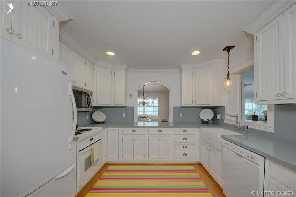 904 Southeast Riverside Drive Stuart, FL 34994 - Photo 33 of 72 a kitchen with stainless steel appliances granite countertop a sink and cabinets