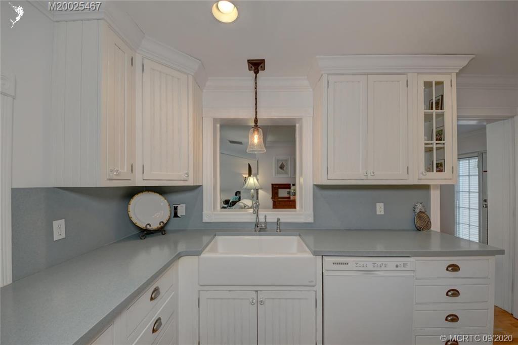 904 Southeast Riverside Drive Stuart, FL 34994 - Photo 34 of 72 a kitchen with a sink and cabinets