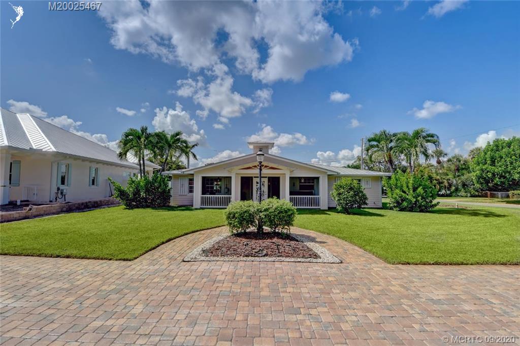 904 Southeast Riverside Drive Stuart, FL 34994 - Photo 4 of 72 a front view of a house with garden