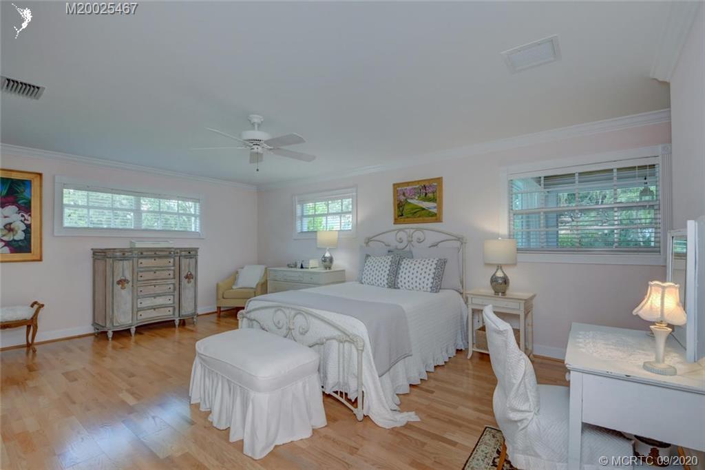904 Southeast Riverside Drive Stuart, FL 34994 - Photo 44 of 72 a bedroom with a bed and wooden floor