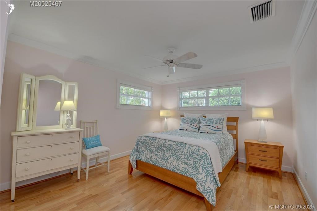 904 Southeast Riverside Drive Stuart, FL 34994 - Photo 49 of 72 a bedroom with a bed and a table