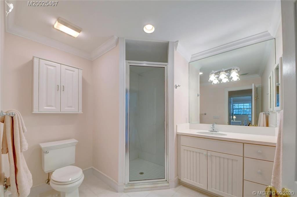 904 Southeast Riverside Drive Stuart, FL 34994 - Photo 50 of 72 a bathroom with a toilet sink and mirror
