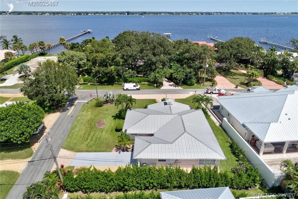 904 Southeast Riverside Drive Stuart, FL 34994 - Photo 58 of 72 an aerial view of a house with a garden and lake view