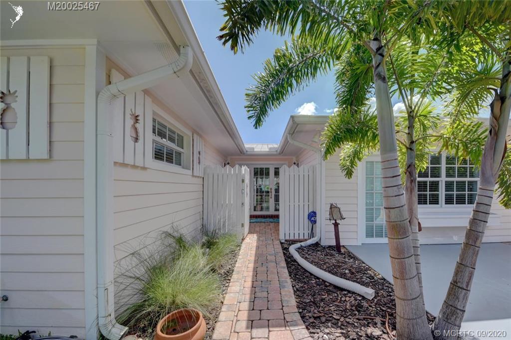 904 Southeast Riverside Drive Stuart, FL 34994 - Photo 6 of 72 a front view of a house with garden