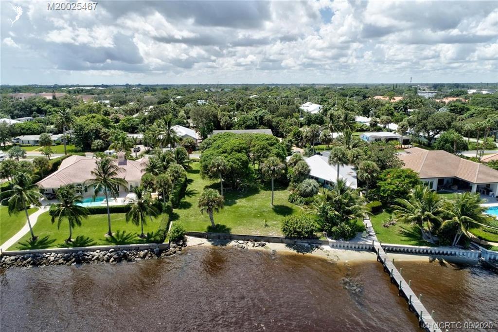 904 Southeast Riverside Drive Stuart, FL 34994 - Photo 71 of 72 an aerial view of a house with a yard and lake view in back