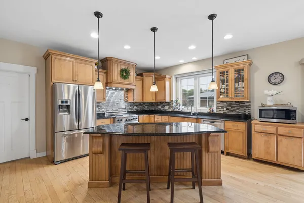 a kitchen with stainless steel appliances granite countertop a stove and refrigerator