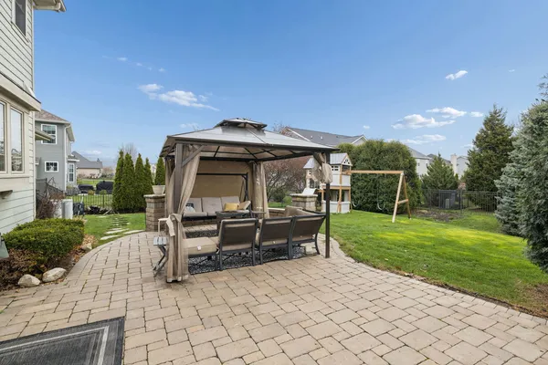a view of a house with a yard and sitting area
