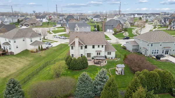 an aerial view of a house with outdoor space and a lake view