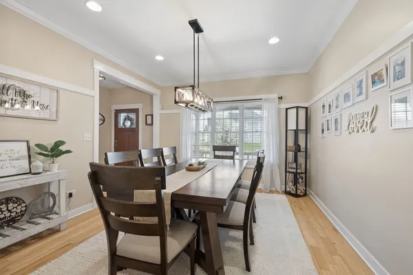 a view of a dining room with furniture window and wooden floor