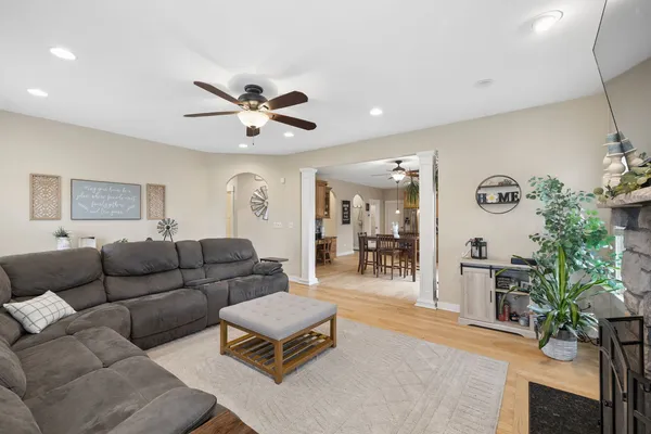 a living room with furniture and wooden floor