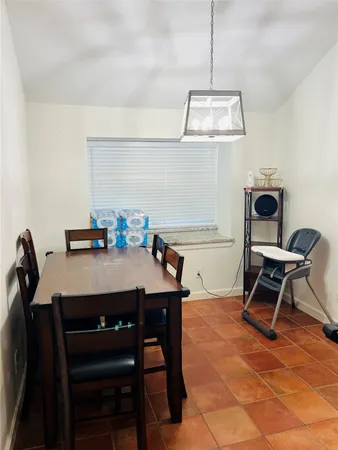a room with a table chairs and a dining table