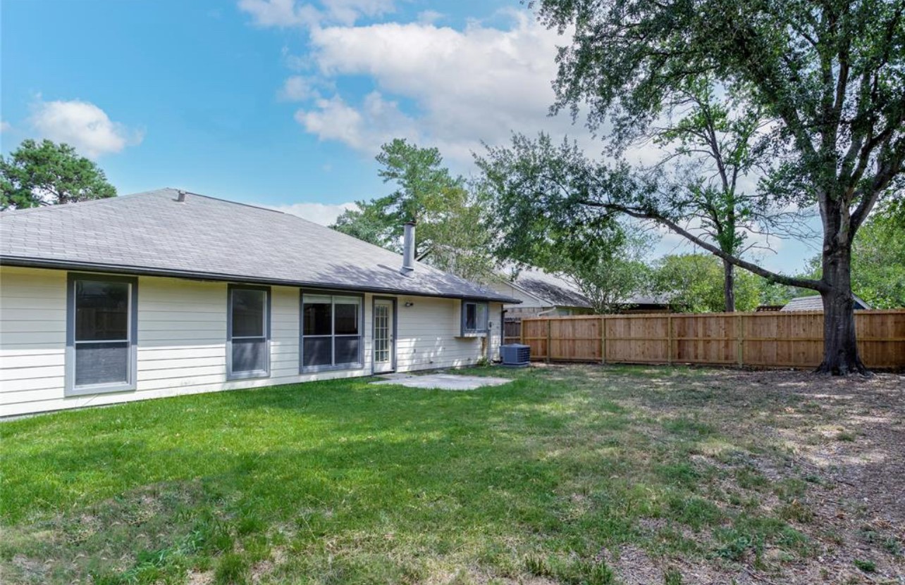 5211 Rivertree Lane Spring, TX 77379 - Photo 18 of 20 a view of a house with a yard and large tree