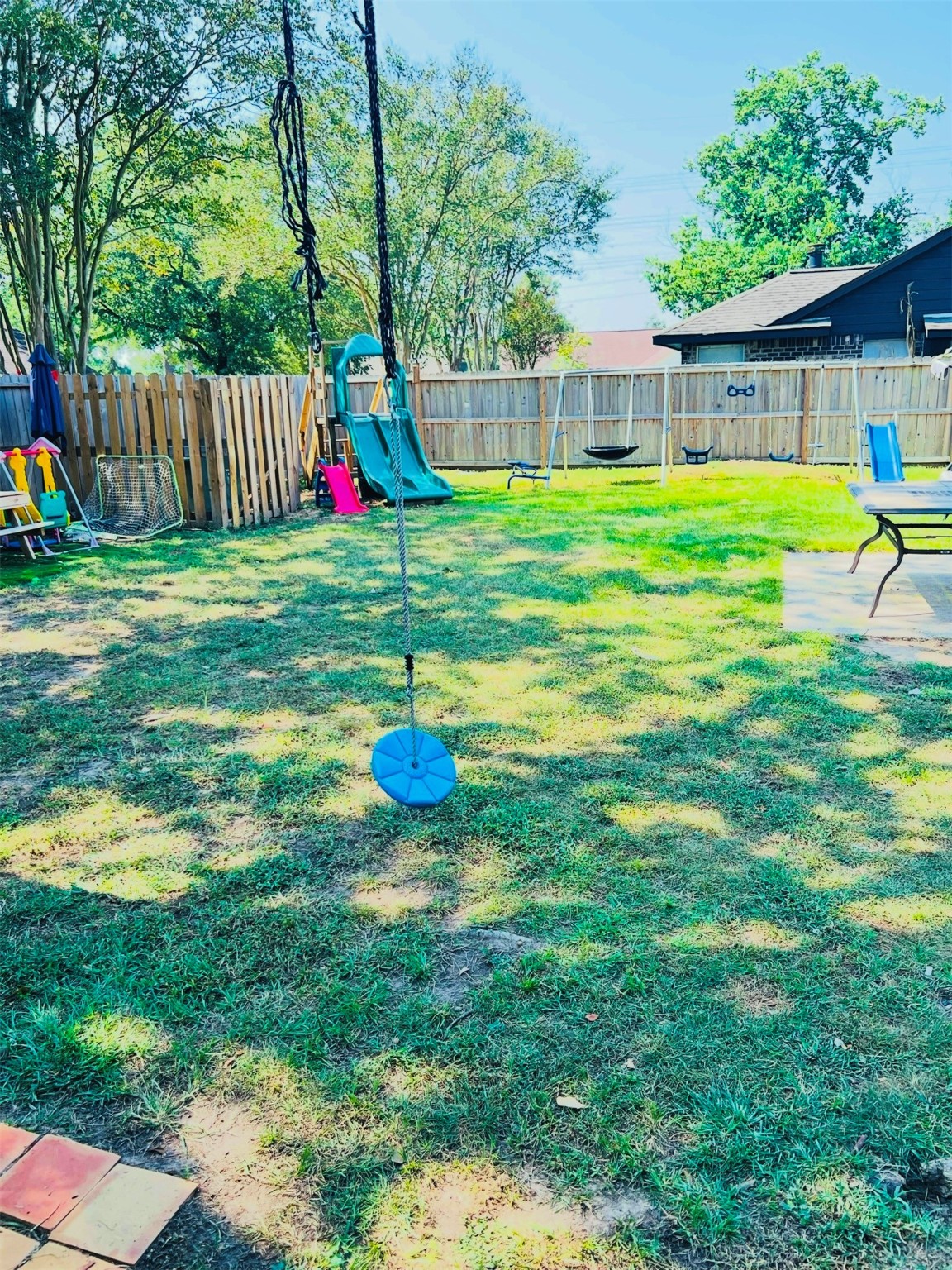 5211 Rivertree Lane Spring, TX 77379 - Photo 19 of 20 a view of a backyard with table and chairs and wooden fence