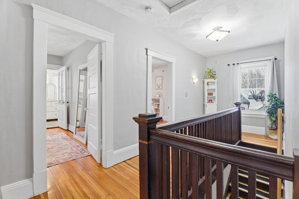 141 Lincoln Road Longmeadow, MA 01106 - Photo 16 of 26 a view of hallway with wooden floor and windows