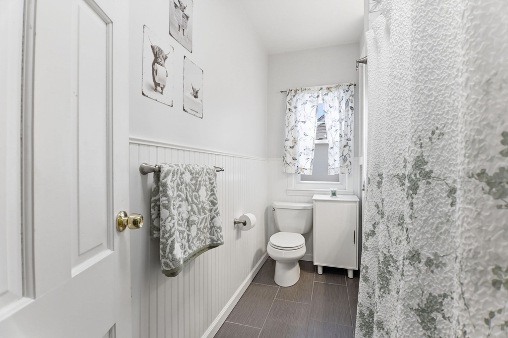 141 Lincoln Road Longmeadow, MA 01106 - Photo 17 of 26 a bathroom with a toilet and a shower curtain