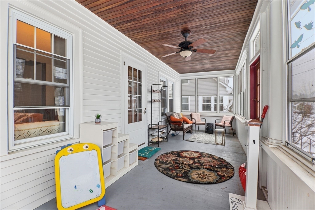 141 Lincoln Road Longmeadow, MA 01106 - Photo 19 of 26 a living room with furniture a fireplace and a large window
