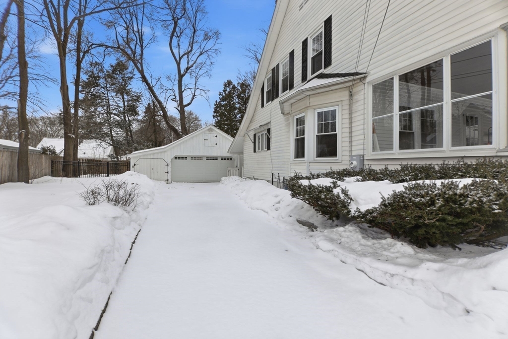 141 Lincoln Road Longmeadow, MA 01106 - Photo 20 of 26 a view of white house with a yard covered in snow