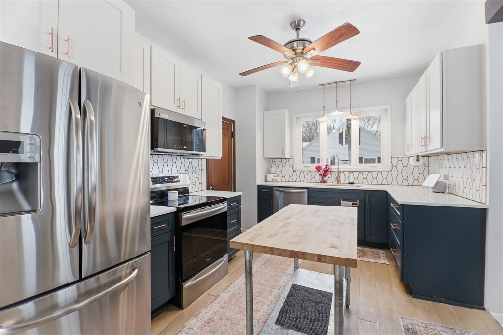 141 Lincoln Road Longmeadow, MA 01106 - Photo 2 of 26 a kitchen with a refrigerator a sink and cabinets