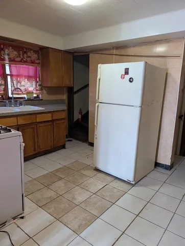 a kitchen with a refrigerator sink and cabinets