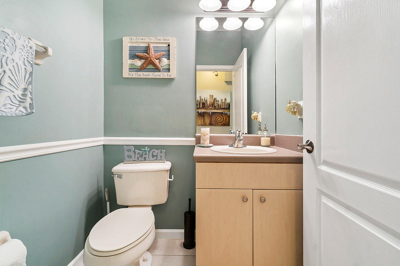 5731 Raceway Road Lake Worth, FL 33449 - Photo 12 of 43 a bathroom with a toilet a sink and mirror