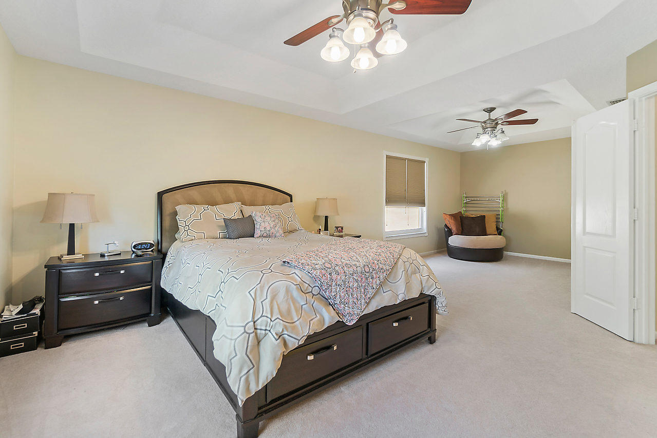 5731 Raceway Road Lake Worth, FL 33449 - Photo 15 of 43 a spacious bedroom with a bed and a chandelier