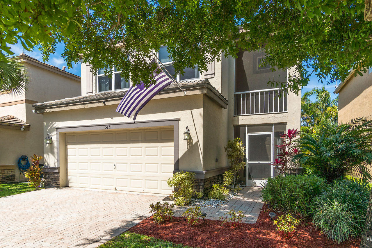 5731 Raceway Road Lake Worth, FL 33449 - Photo 3 of 43 a front view of a house with garden