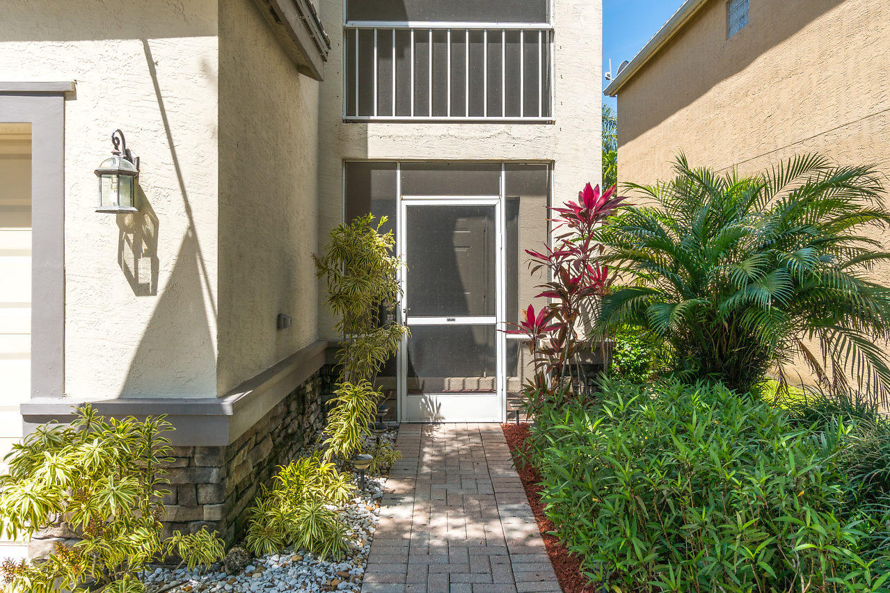5731 Raceway Road Lake Worth, FL 33449 - Photo 4 of 43 a front view of a house with garden