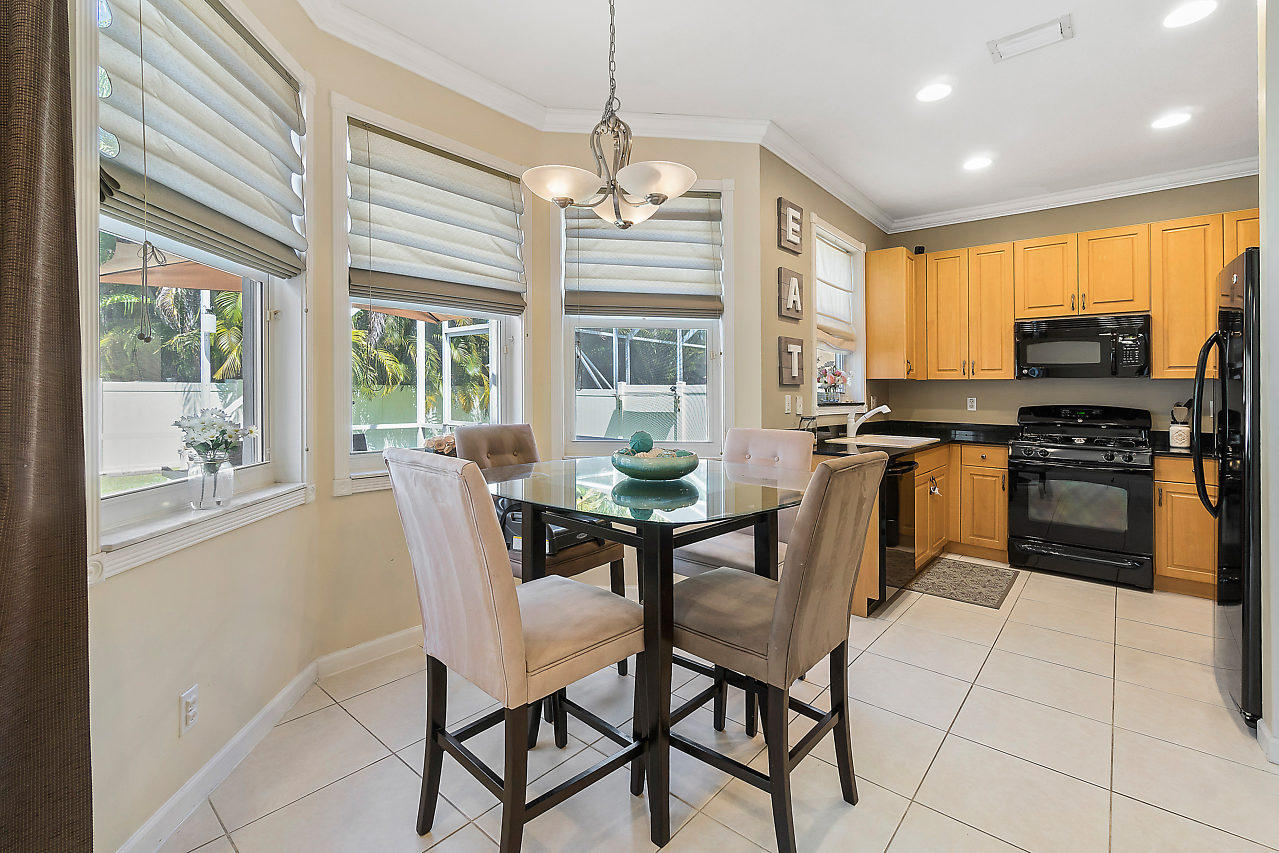 5731 Raceway Road Lake Worth, FL 33449 - Photo 7 of 43 a view of a dining room with furniture large windows and wooden floor
