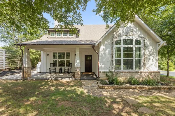 a front view of a house with a garden and patio