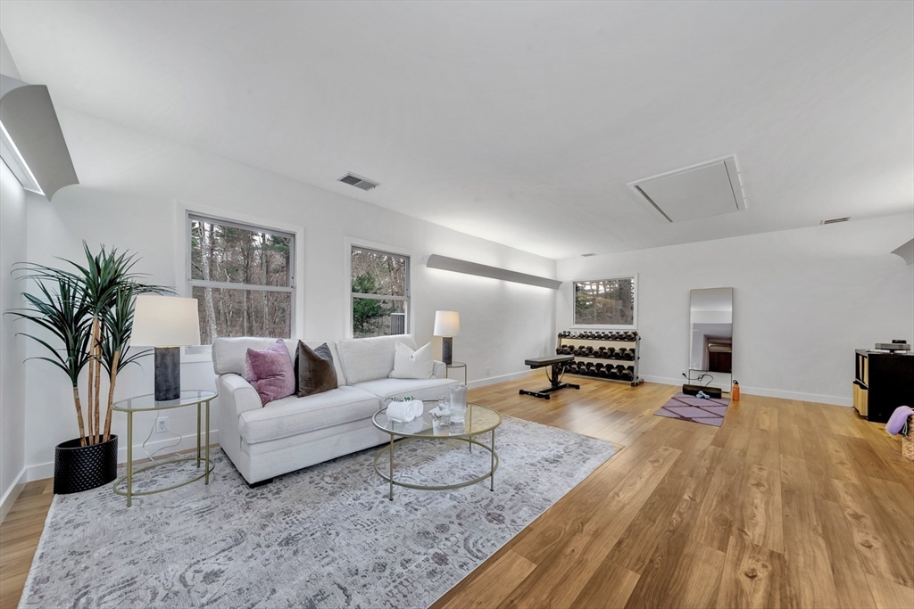 85 The Valley Road Concord, MA 01742 - Photo 34 of 38 a living room with furniture and a wooden floor