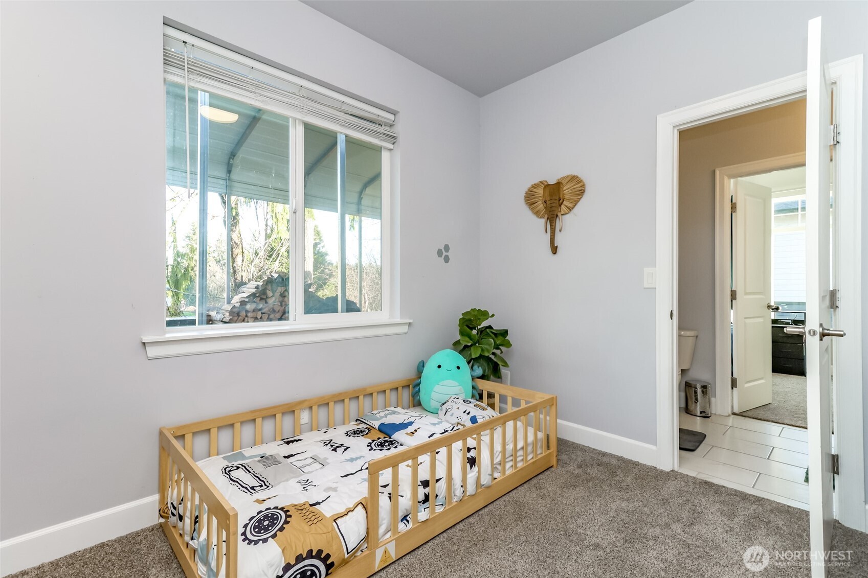 30904 37th Avenue East Graham, WA 98338 - Photo 19 of 40 a bed sitting in a bedroom next to a window