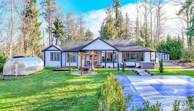 a front view of a house with garden and porch
