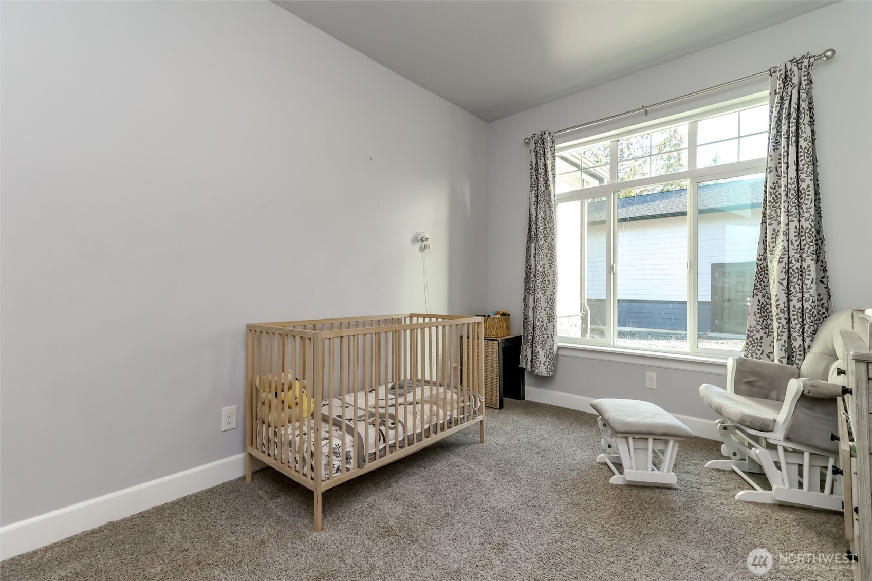 30904 37th Avenue East Graham, WA 98338 - Photo 21 of 40 a bed sitting in a room next to a window