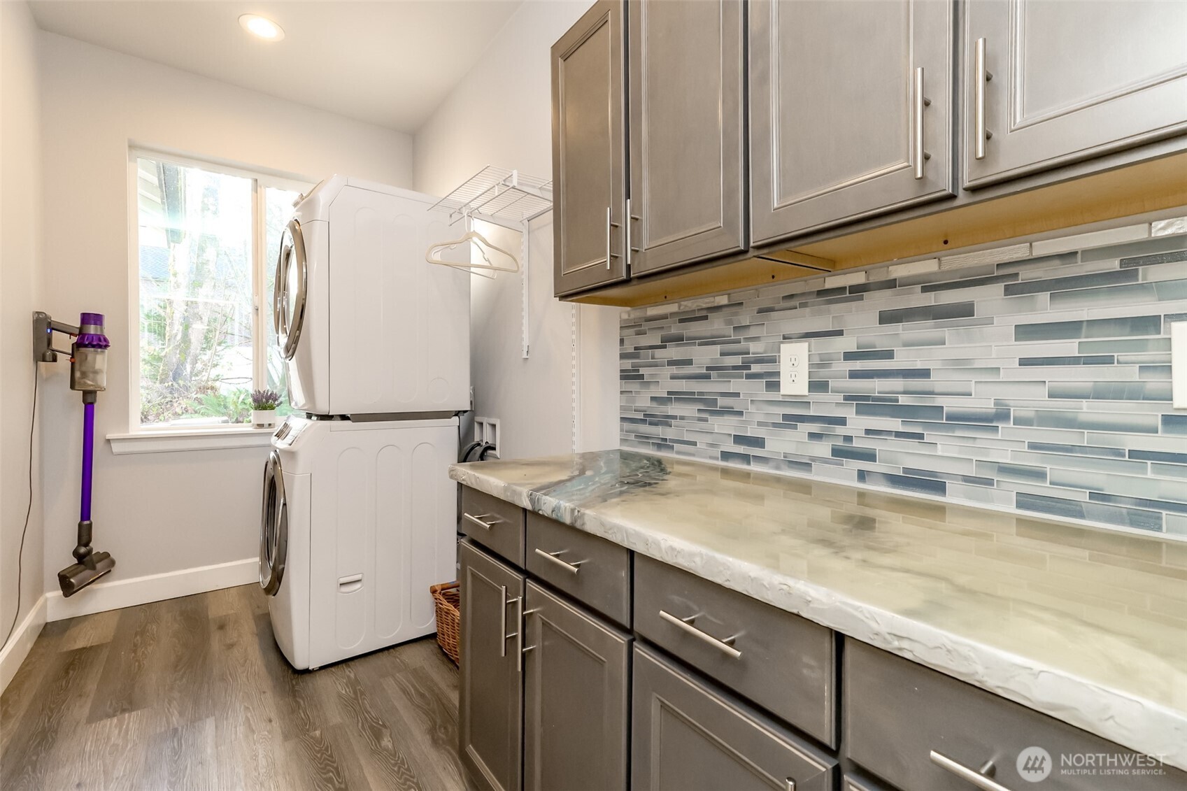 30904 37th Avenue East Graham, WA 98338 - Photo 22 of 40 a kitchen with granite countertop a sink cabinets stainless steel appliances and a window
