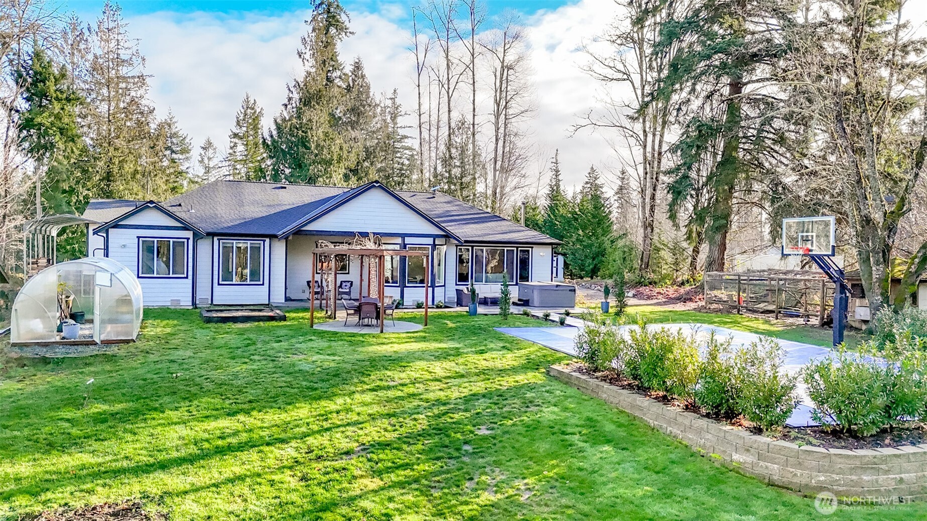 30904 37th Avenue East Graham, WA 98338 - Photo 23 of 40 a front view of a house with garden and trees