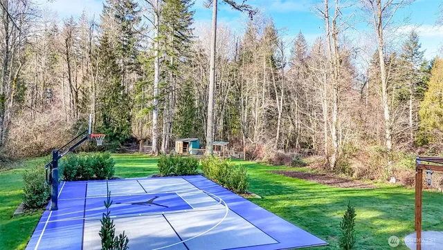 a view of a house with a yard and garden