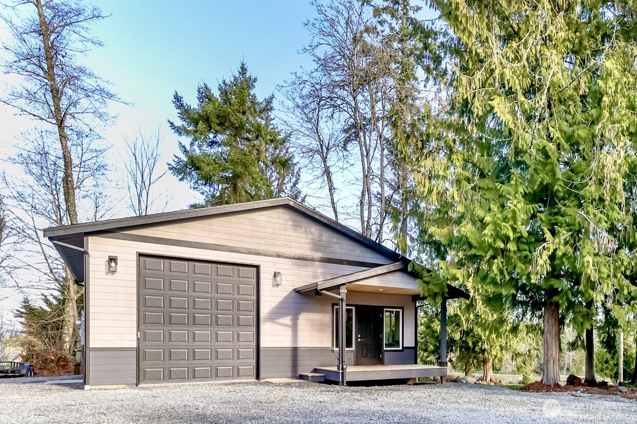 30904 37th Avenue East Graham, WA 98338 - Photo 30 of 40 a view of a house with a tree and balcony