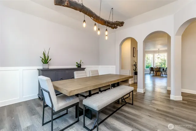 a kitchen with a table chairs refrigerator and chairs