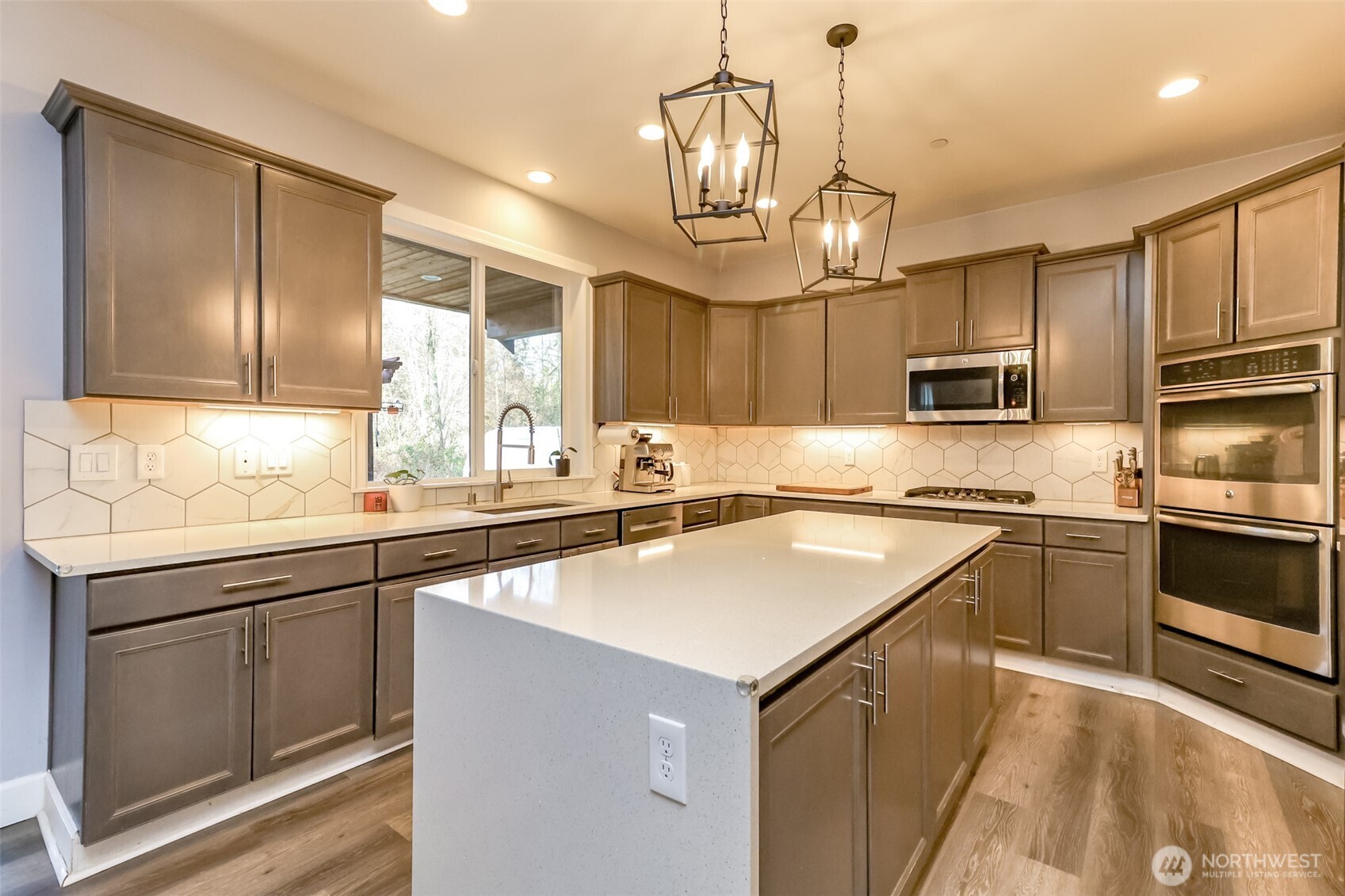 30904 37th Avenue East Graham, WA 98338 - Photo 8 of 40 a kitchen with kitchen island granite countertop stainless steel appliances cabinets a sink and a counter top